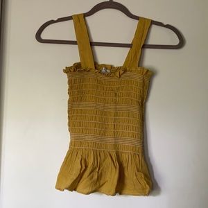 Mustard yellow tank top with white stitching